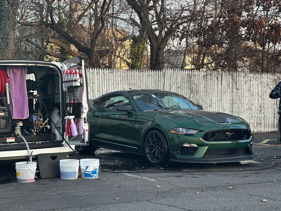 Mobile detailing van with a green Mustang