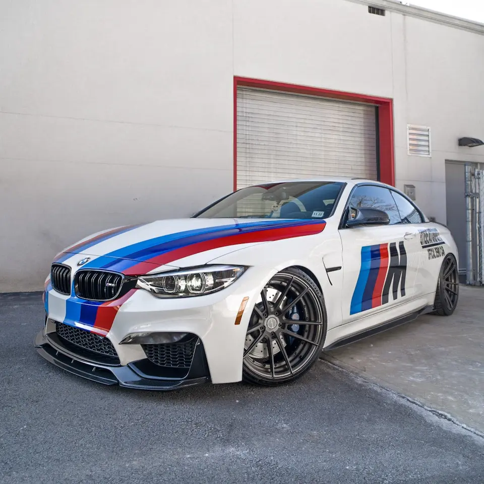 BMW M4 with livery on aftermarket wheels outside the Paramus shop
