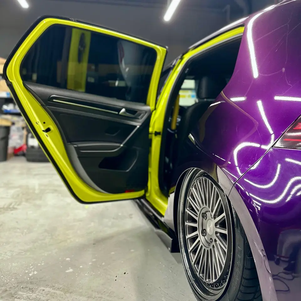 Yellow wrapped door jambs on a purple Golf R